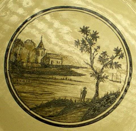 Assiette décorée d'un paysage.