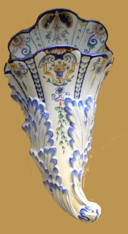 Vase d'applique à décor floral polychrome.